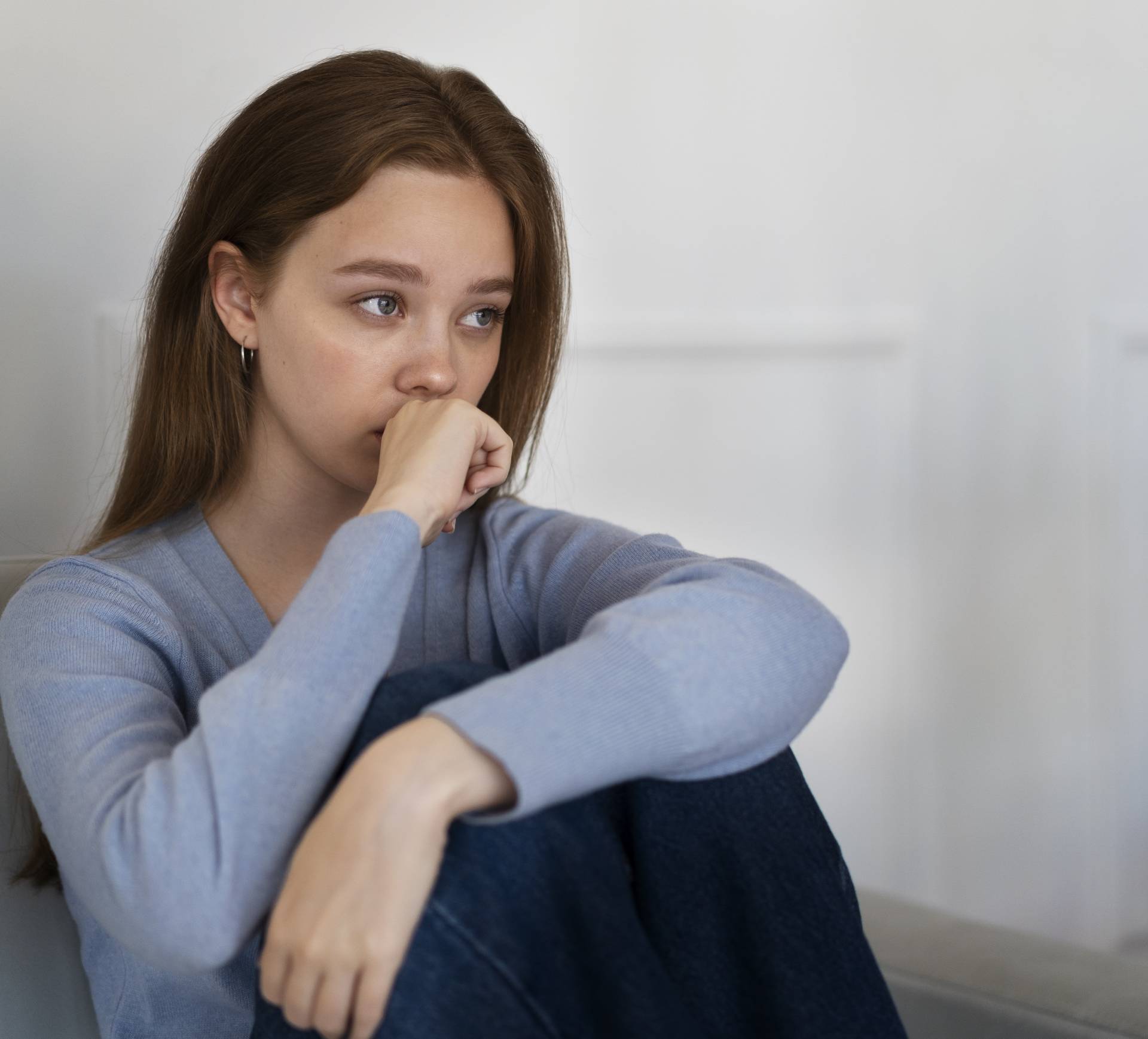 side-view-worried-woman-sitting-couch